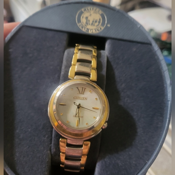 Citizens women's Eco-Drive watch with a pearl face and gold trim and a gold hand - Picture 7 of 13